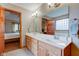 Well-lit bathroom features double sinks, large mirrors, and access to the bedroom at 691 Walnut Woods Dr, Greenwood, IN 46142
