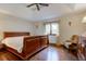 Bedroom with hardwood floors, large bed, and plenty of natural light at 691 Walnut Woods Dr, Greenwood, IN 46142