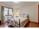 Charming bedroom featuring hardwood floors, a decorative bed, and a window at 691 Walnut Woods Dr, Greenwood, IN 46142