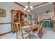 Elegant dining room with wood table and hutch, chandelier and neutral carpet and trim at 691 Walnut Woods Dr, Greenwood, IN 46142