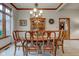Elegant dining room with beautiful china cabinet, a table set for six, and a decorative chandelier at 691 Walnut Woods Dr, Greenwood, IN 46142