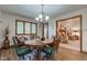 Bright dining room with wood floors, chandelier, and view to living room at 691 Walnut Woods Dr, Greenwood, IN 46142