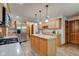 Bright kitchen with island, wood cabinets, stainless appliances and wood flooring at 691 Walnut Woods Dr, Greenwood, IN 46142