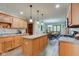 Bright eat-in kitchen with island, wooden cabinetry, stainless appliances and wood flooring at 691 Walnut Woods Dr, Greenwood, IN 46142