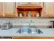 Kitchen features a stainless steel sink, stone countertops and wooden cabinetry at 691 Walnut Woods Dr, Greenwood, IN 46142