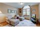 Cozy living room with a large arched window, soft chairs, and a colorful patterned rug at 691 Walnut Woods Dr, Greenwood, IN 46142
