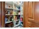 Organized pantry with shelves stocked with food items and household goods at 691 Walnut Woods Dr, Greenwood, IN 46142