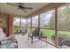 Inviting screened porch with comfortable seating and ceiling fan overlooking the backyard at 691 Walnut Woods Dr, Greenwood, IN 46142