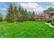 Lush green lawn and mature trees surround this well-maintained property at 691 Walnut Woods Dr, Greenwood, IN 46142