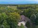 Aerial view of beautiful home surrounded by mature trees and beautiful scenery at 9943 Irishman'S Run Ln, Zionsville, IN 46077