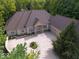 Aerial view of a brick home with a large driveway and well-manicured lawn at 9943 Irishman'S Run Ln, Zionsville, IN 46077