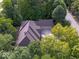 An aerial shot of a home showcasing a three-car garage, a well-maintained roof, and lush, mature trees at 9943 Irishman'S Run Ln, Zionsville, IN 46077