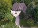 Aerial view of a brick home featuring mature trees, and a large driveway at 9943 Irishman'S Run Ln, Zionsville, IN 46077