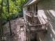 Backyard view highlighting a charming brick home with a spacious patio and wooden stairs, perfect for entertaining at 9943 Irishman'S Run Ln, Zionsville, IN 46077