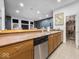 Basement bar area with sink, cabinets, lighting and wine display, ready to host your next gathering at 9943 Irishman'S Run Ln, Zionsville, IN 46077