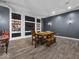 Basement with space for games and gatherings, and decorated with dark walls and lighting at 9943 Irishman'S Run Ln, Zionsville, IN 46077