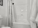 Bright white bathroom with a shower-tub combination and modern fixtures at 9943 Irishman'S Run Ln, Zionsville, IN 46077