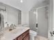 Bathroom featuring vanity sink with wooden cabinets and walk-in shower with glass door at 9943 Irishman'S Run Ln, Zionsville, IN 46077