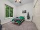 Well-lit bedroom featuring a large window offering views of the surrounding lush greenery at 9943 Irishman'S Run Ln, Zionsville, IN 46077