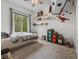 bedroom featuring playful decor, a large window, shelving and carpeted floor at 9943 Irishman'S Run Ln, Zionsville, IN 46077