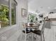 A dining area adjacent to the kitchen, featuring a round table, chairs, and a view into the living room at 9943 Irishman'S Run Ln, Zionsville, IN 46077