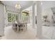 Bright dining room with large windows, chandelier, and ample seating at 9943 Irishman'S Run Ln, Zionsville, IN 46077