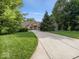 Beautiful home with a well-manicured lawn and mature trees surrounding the property at 9943 Irishman'S Run Ln, Zionsville, IN 46077