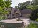 Beautiful exterior with a circular driveway, detailed landscaping, and a three car garage at 9943 Irishman'S Run Ln, Zionsville, IN 46077