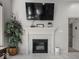 A living room with a fireplace featuring a decorated mantle, creating a warm and inviting space at 9943 Irishman'S Run Ln, Zionsville, IN 46077