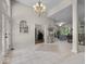 Open concept foyer featuring grand staircase, chandelier, and tile flooring at 9943 Irishman'S Run Ln, Zionsville, IN 46077