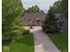 Brick home with a large front lawn and a circular driveway at 9943 Irishman'S Run Ln, Zionsville, IN 46077