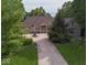 Brick home with a large front lawn and a circular driveway at 9943 Irishman'S Run Ln, Zionsville, IN 46077