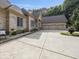 Brick home featuring a spacious front yard, three-car garage, and flower beds at 9943 Irishman'S Run Ln, Zionsville, IN 46077