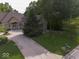 Scenic view of the home showcasing the long driveway and green lawn at 9943 Irishman'S Run Ln, Zionsville, IN 46077