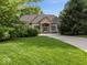Charming one-story home with well-manicured lawn and inviting front entrance at 9943 Irishman'S Run Ln, Zionsville, IN 46077
