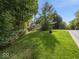 Picture of a home with a beautiful lawn, mature trees, and a circular driveway adding to the property's curb appeal at 9943 Irishman'S Run Ln, Zionsville, IN 46077