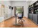 Bright home office featuring hardwood floors, built-in bookshelves, and large windows providing natural light at 9943 Irishman'S Run Ln, Zionsville, IN 46077