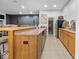 Spacious kitchen area with wooden cabinets, tile flooring, and dining space at 9943 Irishman'S Run Ln, Zionsville, IN 46077