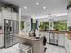 Spacious kitchen with stainless steel appliances, center island, and bright windows at 9943 Irishman'S Run Ln, Zionsville, IN 46077
