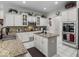 A kitchen with white cabinets, granite countertops, and stainless steel appliances, creating a bright and functional space at 9943 Irishman'S Run Ln, Zionsville, IN 46077