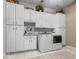 Functional laundry room featuring storage cabinets, a utility sink, and modern washer and dryer at 9943 Irishman'S Run Ln, Zionsville, IN 46077