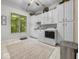 Bright laundry room with ample white cabinets, large window, and modern washer and dryer at 9943 Irishman'S Run Ln, Zionsville, IN 46077