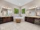 Bright main bathroom with double vanities, soaking tub, and views of nature at 9943 Irishman'S Run Ln, Zionsville, IN 46077