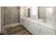 Bathroom featuring double sink vanity with white cabinets and glass shower at 4982 Reavie Ct, Noblesville, IN 46062