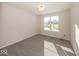 Bedroom with gray carpet and bright window, with a window sticker at 4982 Reavie Ct, Noblesville, IN 46062