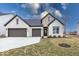Charming brick home featuring a three car garage and well-manicured lawn at 4982 Reavie Ct, Noblesville, IN 46062