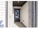 Exterior view of the beautiful brick entryway featuring a stylish black front door at 4982 Reavie Ct, Noblesville, IN 46062