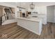 Spacious kitchen with a large island, white cabinetry, and modern pendant lighting at 4982 Reavie Ct, Noblesville, IN 46062