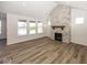 Spacious living room featuring a stone fireplace, large windows and beautiful floors at 4982 Reavie Ct, Noblesville, IN 46062