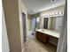Well-lit bathroom with a combination tub and shower, single vanity, and decorative tile flooring at 1946 Central Park W Blvd, Greenwood, IN 46143